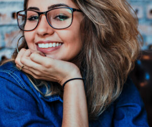 Girl smiling with glasses testimonial1@2x